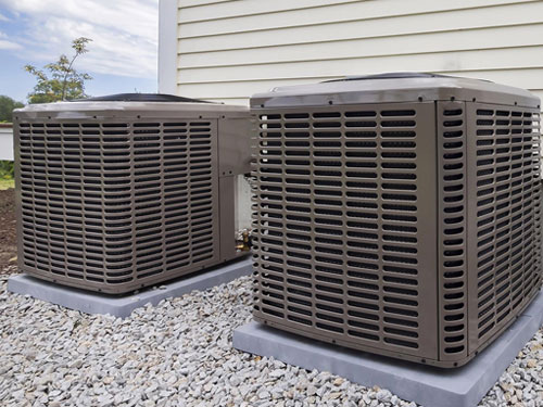 two air conditioning units outside a single family home