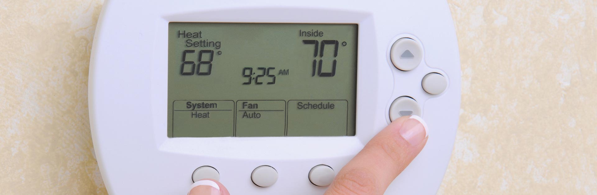 person adjusting a white home air conditioner wall unit