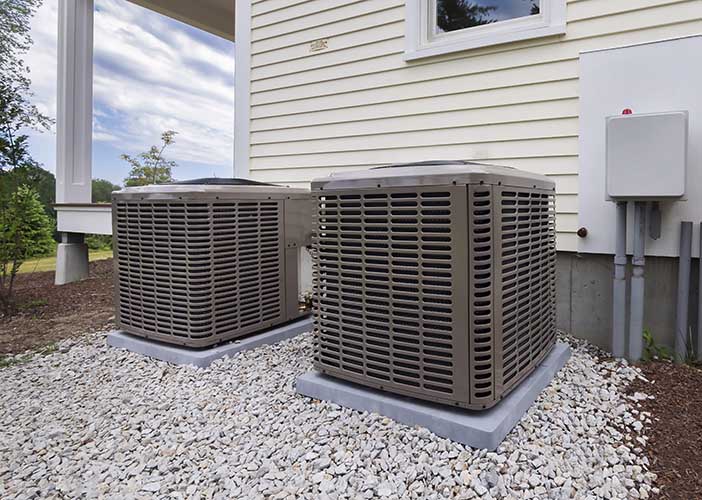 two air conditioning units outside a single family home